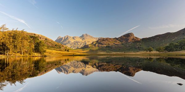 Blea Tarn panoramic view towards the Langdale Pikes with mountain reflections in the Lake District